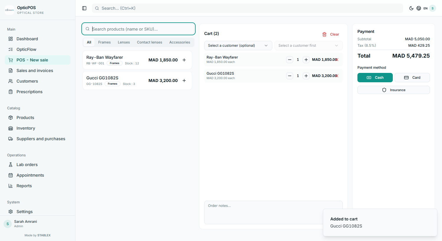 OpticPOS checkout screen with frame catalog, cart, and payment total for an optical store
